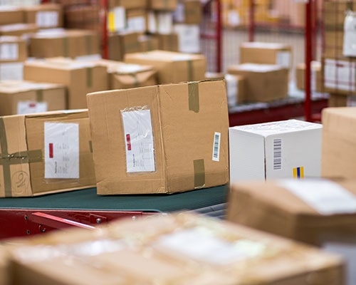 Cardboard Box Packages on Conveyor Belt